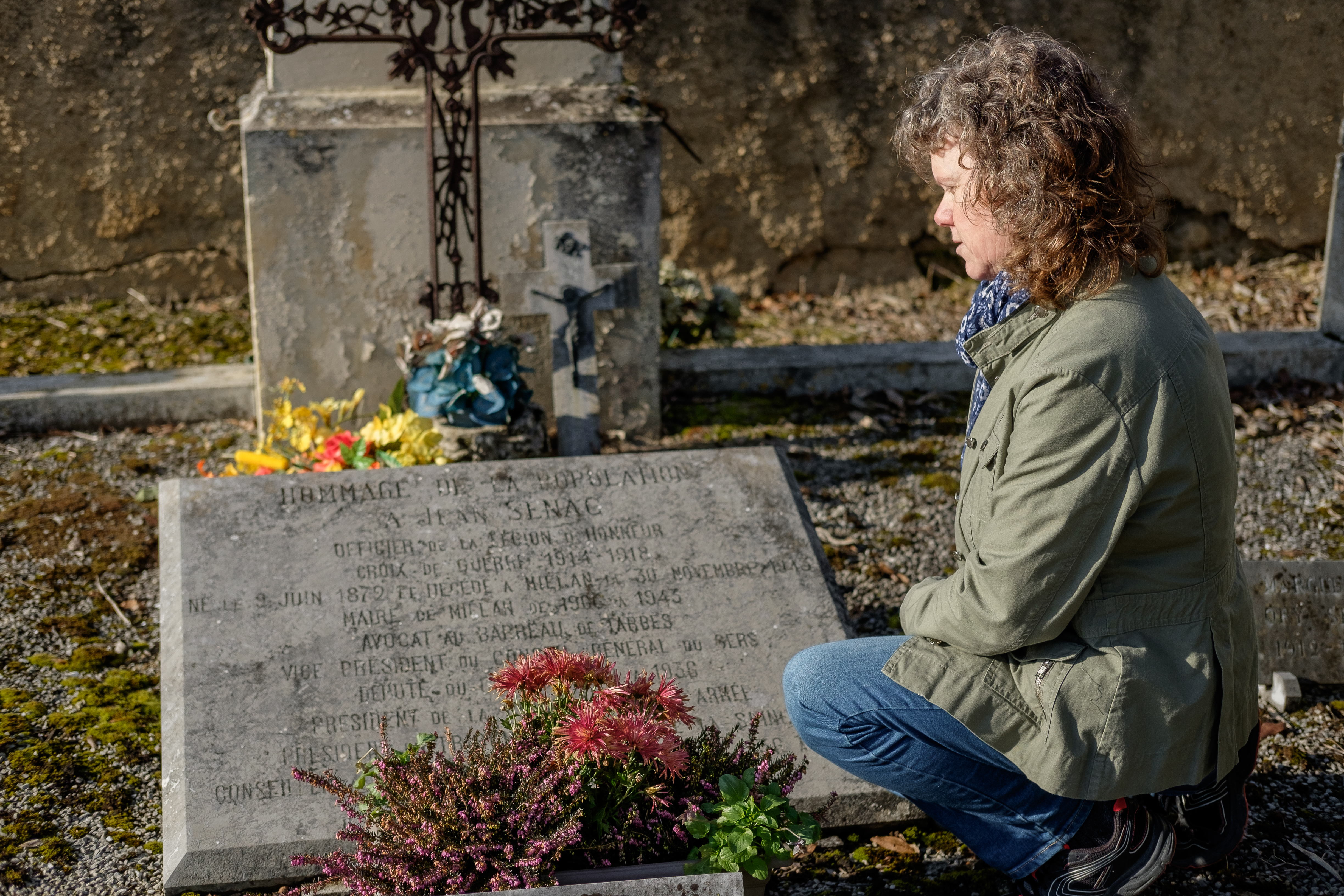 Linda Hammond examining a historic gravestone as part of genealogical research